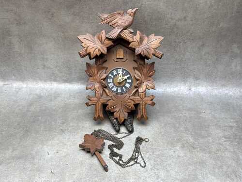 Timber cuckoo clock with pendulum and weights