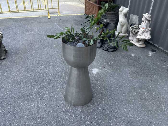 Stainless steel planter with plant