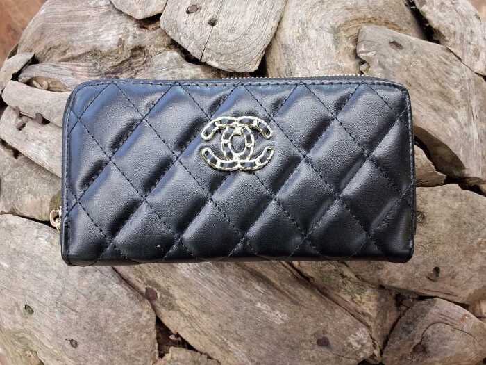 Designer-style black quilted purse with gold-tone hardware.