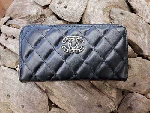 Designer-style black quilted purse with gold-tone hardware.