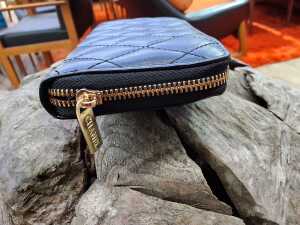 Designer-style black quilted purse with gold-tone hardware. - 3