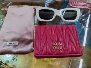 Designer-style items, including white sunglasses and a pink coin purse - 2
