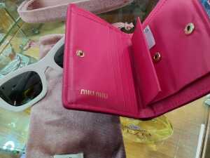 Designer-style items, including white sunglasses and a pink coin purse - 3