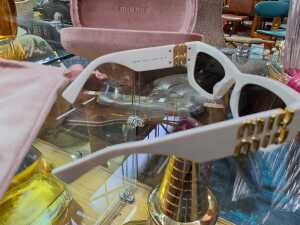 Designer-style items, including white sunglasses and a pink coin purse - 4