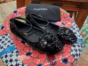 Designer-style black patent ballet flats with slip bag.