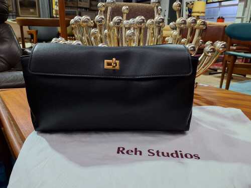 Designer-style black leather handbag with gold-tone hardware.