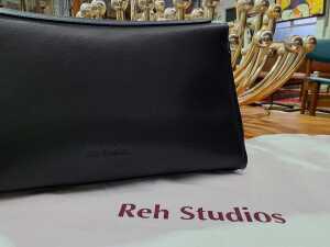 Designer-style black leather handbag with gold-tone hardware. - 2