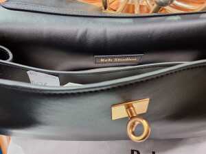 Designer-style black leather handbag with gold-tone hardware. - 3