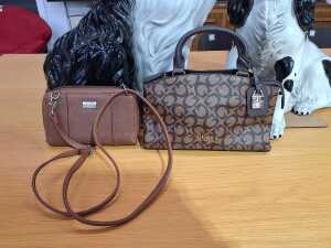 Two designer-style handbags in brown and chocolate tones