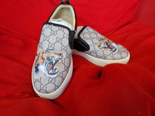Pair of designer style slip-on canvas shoes with lion motif, size 37