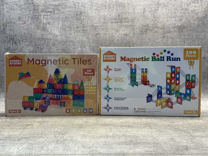 Two boxes of Steam Studio magnetic tiles