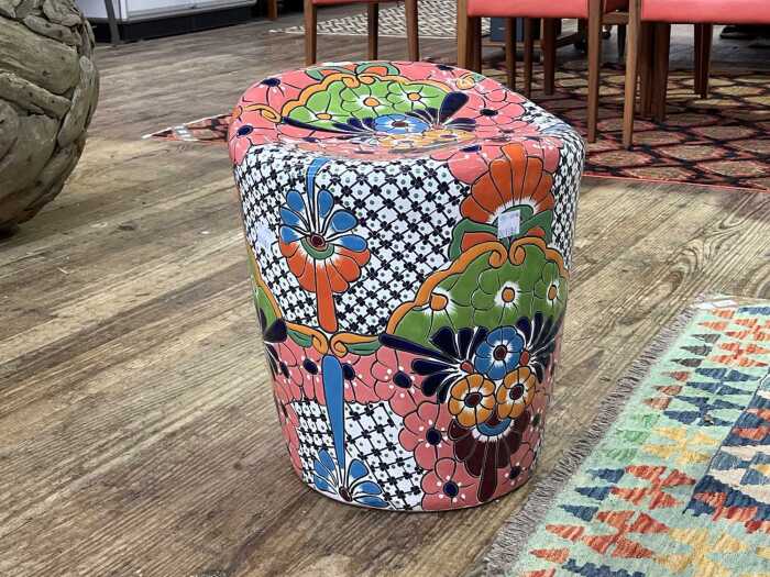 Modern terracotta garden seat with bold glazed floral decoration