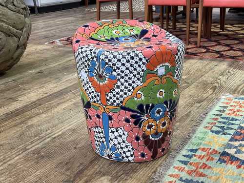 Modern terracotta garden seat with bold glazed floral decoration
