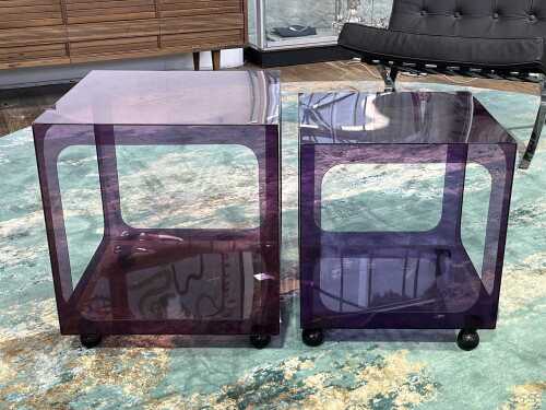 Two mid-century transparent acrylic purple side tables in graduating sizes