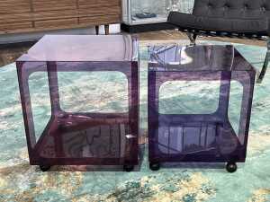 Two mid-century transparent acrylic purple side tables in graduating sizes