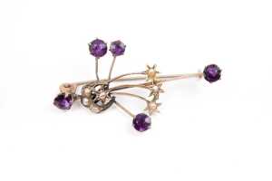 An antique amethyst and seed pearl brooch in 9 carat yellow gold
