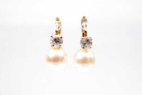 A pair pearl and cubic zirconia earrings in 18 carat yellow gold