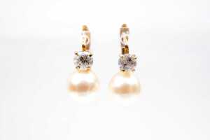 A pair pearl and cubic zirconia earrings in 18 carat yellow gold