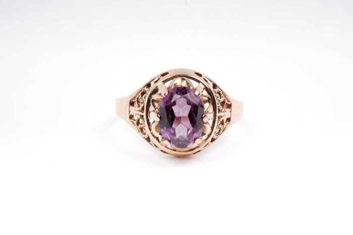 A synthetic purple sapphire ring in 14 carat rose gold.