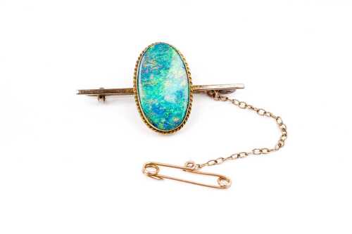A vintage opal doublet brooch in 9 carat yellow gold