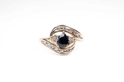 A sapphire and diamond ring in 9 carat yellow gold