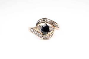 A sapphire and diamond ring in 9 carat yellow gold