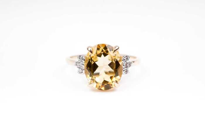 A citrine and diamond ring in 9 carat yellow gold