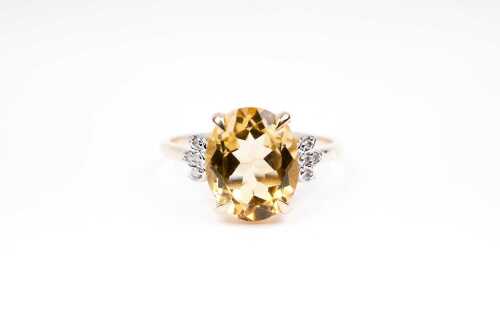 A citrine and diamond ring in 9 carat yellow gold