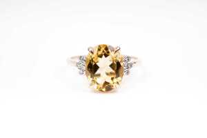 A citrine and diamond ring in 9 carat yellow gold