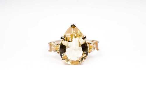 A citrine and diamond ring in 9 carat yellow gold