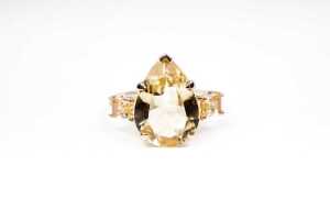 A citrine and diamond ring in 9 carat yellow gold