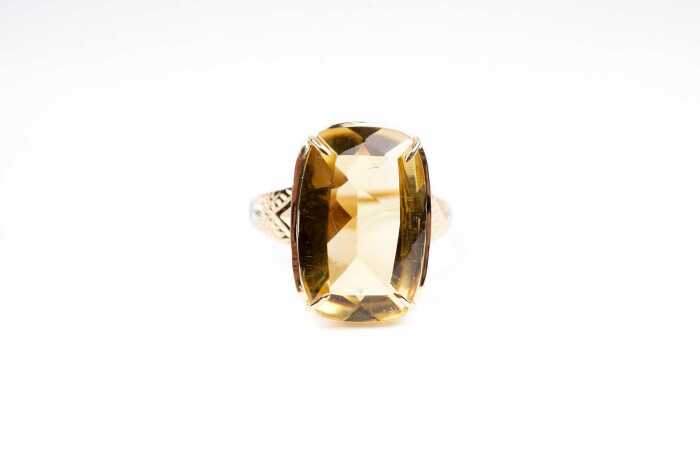 A citrine and diamond ring in 9 carat yellow gold