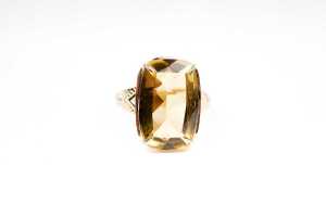A citrine and diamond ring in 9 carat yellow gold