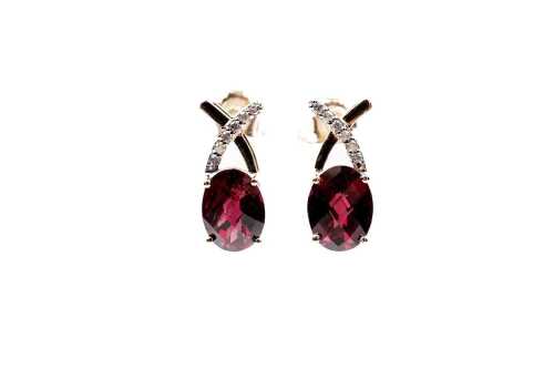 A pair of garnet and diamond earrings in 9 carat yellow gold
