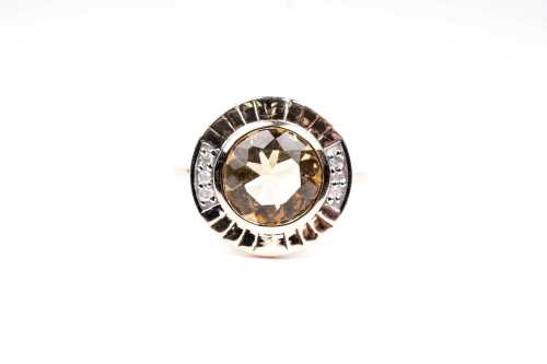 A citrine and diamond ring in 9 carat yellow gold