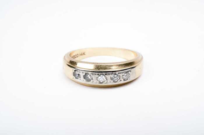 A diamond band in 14 carat yellow gold