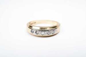 A diamond band in 14 carat yellow gold
