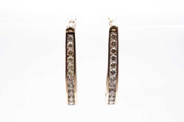 A pair of diamond hoops in 9 carat yellow gold