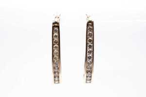 A pair of diamond hoops in 9 carat yellow gold