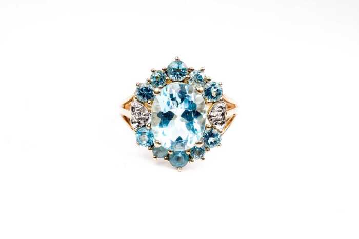 A blue topaz and diamond ring in 14 carat yellow gold