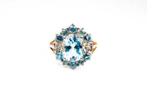 A blue topaz and diamond ring in 14 carat yellow gold