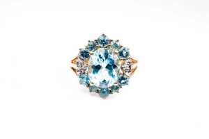 A blue topaz and diamond ring in 14 carat yellow gold