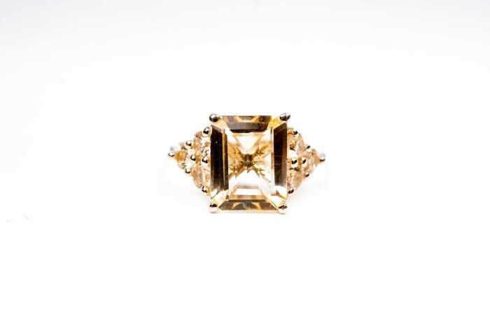 A citrine and diamond ring in 9 carat yellow gold