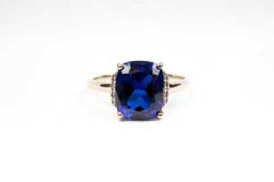 A synthetic sapphire and diamond ring in 9 carat yellow gold