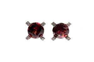 A pair of garnet and diamond earrings in 9 carat yellow gold