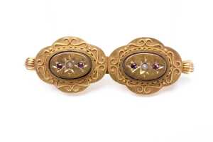 An antique seed pearl and garnet brooch in 15ct yellow gold