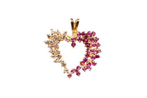 A ruby and diamond pendant in 14 carat yellow gold