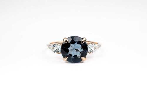 A blue topaz and diamond ring in 9 carat yellow gold