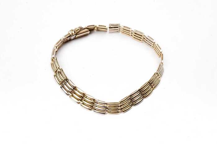 An Italian gate link bracelet in 14 carat yellow and white gold