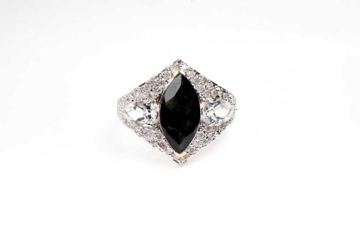 A green tourmaline, white topaz and diamond ring in 9 carat yellow gold
